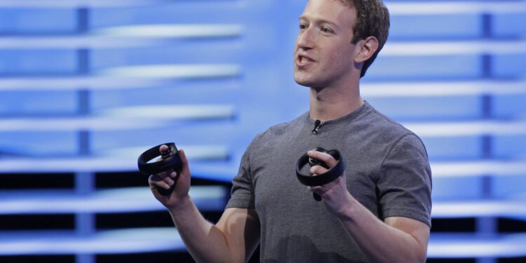 Meta-CEO Mark Zuckerberg hält zwei Controller in der Hand.
